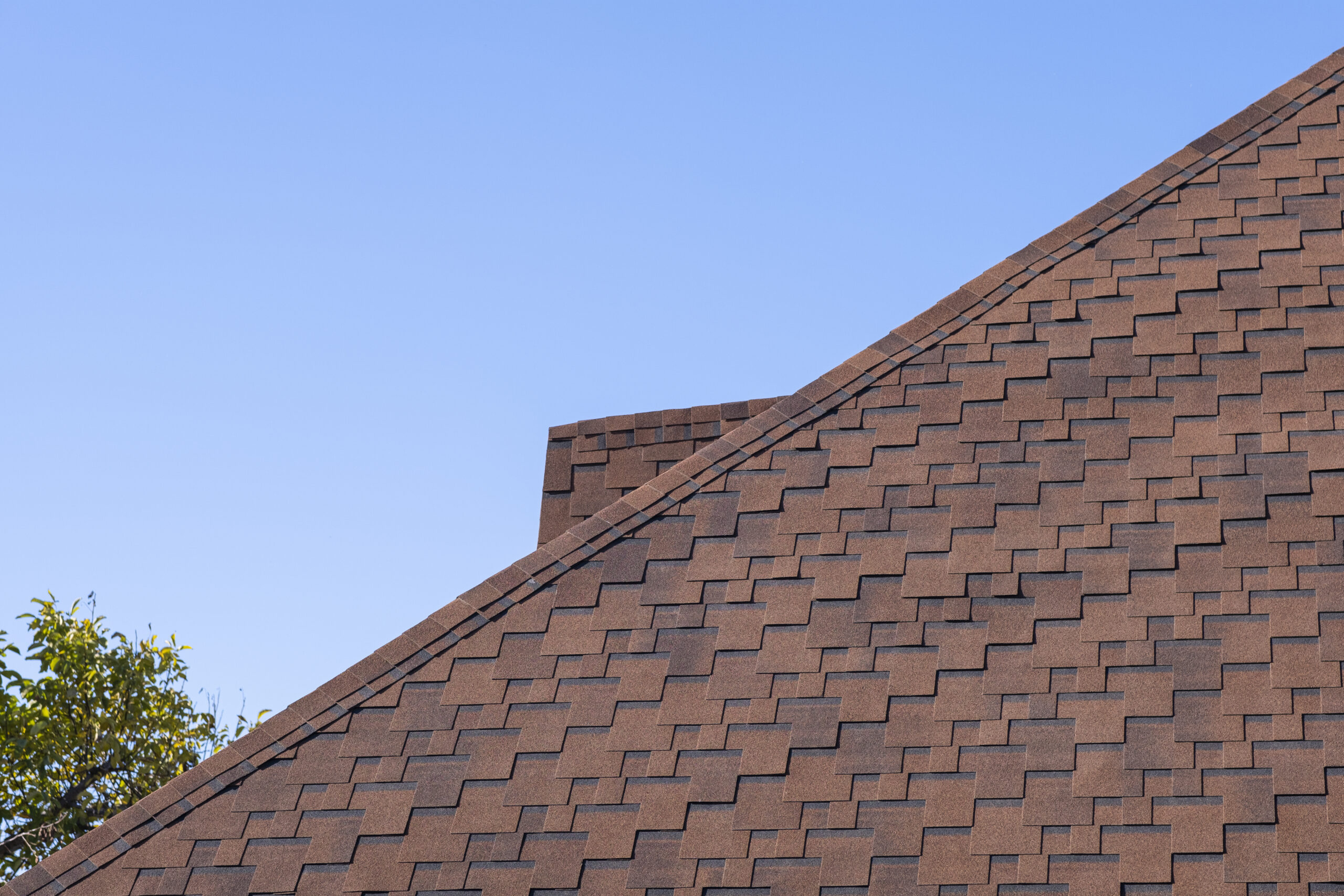 The Roof Is Made Of Brown Bituminous Tiles.